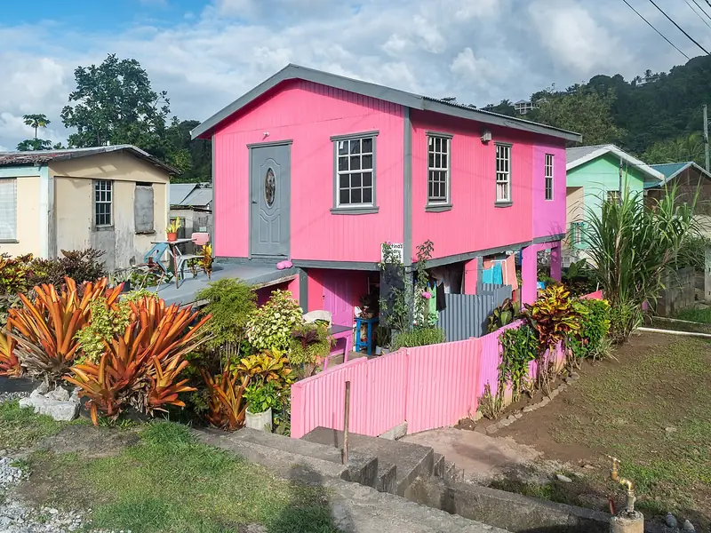 Bright pink house with tropical plants in Calibishie, Dominica
